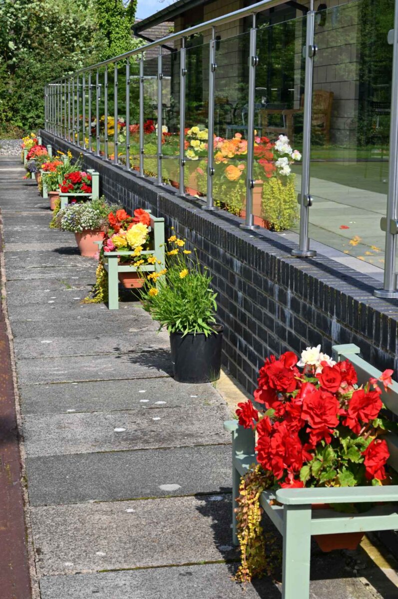 Flower benches lined up along the edge of the green